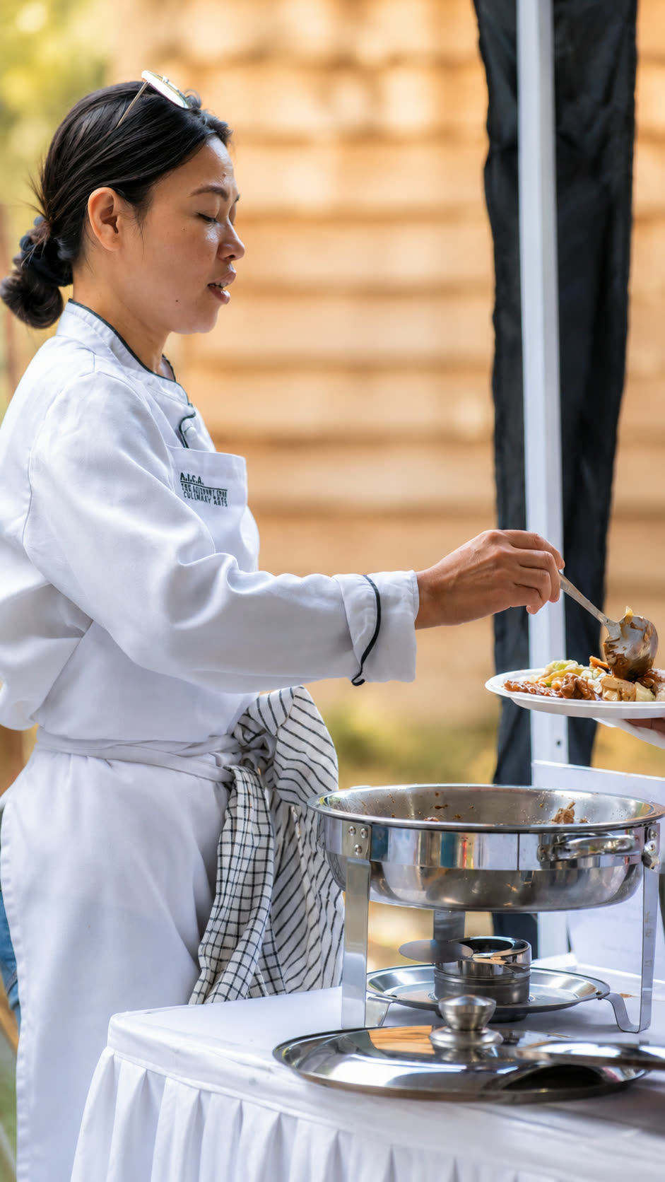 Filipino Fiesta Food chef plating a dish for a guest